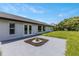 Home's rear exterior with a view of the backyard, well-kept lawn, and a small garden at 17 S Flag Ct, Kissimmee, FL 34759