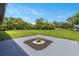Large backyard featuring a well-maintained lawn, mature trees and a small garden at 17 S Flag Ct, Kissimmee, FL 34759