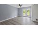 Bedroom featuring a ceiling fan, wood-look floors, and access to the backyard at 17 S Flag Ct, Kissimmee, FL 34759