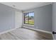 Light-filled bedroom with wood-look floors, double closet and a window overlooking the neighborhood at 17 S Flag Ct, Kissimmee, FL 34759