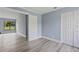 View of bedroom with open closet, wood-look floors, and attached room at 17 S Flag Ct, Kissimmee, FL 34759