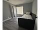View of a bedroom with a daybed, closet, window with blinds and wood-look floors at 17 S Flag Ct, Kissimmee, FL 34759