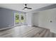 Bedroom features a ceiling fan, wood-look floors, a closet and access to the backyard at 17 S Flag Ct, Kissimmee, FL 34759