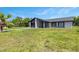 Single-story home featuring a modern color scheme and well-maintained lawn and landscape at 17 S Flag Ct, Kissimmee, FL 34759