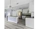 Modern kitchen with stainless steel appliances, gray countertops, white cabinets, and an open layout into other rooms at 17 S Flag Ct, Kissimmee, FL 34759