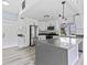 Bright kitchen featuring stainless steel appliances, white cabinets, and a large center island at 17 S Flag Ct, Kissimmee, FL 34759
