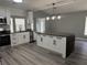 Modern kitchen features a large island, stainless steel appliances, and sleek cabinetry at 17 S Flag Ct, Kissimmee, FL 34759