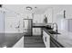 Modern kitchen with stainless steel appliances, white cabinets, black hardware, and gray countertops at 17 S Flag Ct, Kissimmee, FL 34759
