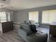 Cozy living room with an open floor plan, featuring a comfortable gray sectional couch and plenty of natural light at 17 S Flag Ct, Kissimmee, FL 34759