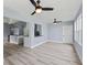 Open concept living and kitchen area featuring gray wood floors, recessed lighting, and a view into the kitchen at 17 S Flag Ct, Kissimmee, FL 34759