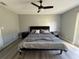 Comfortable bedroom with modern ceiling fan, wood-look floors, and access to the backyard at 17 S Flag Ct, Kissimmee, FL 34759