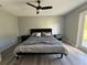 Comfortable bedroom with modern ceiling fan, wood-look floors, and access to the backyard at 17 S Flag Ct, Kissimmee, FL 34759