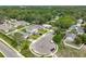 Aerial view of a residential neighborhood featuring well-manicured lawns, mature trees, and various home styles, in a suburban setting at 171 Stanley Bell Dr, Mount Dora, FL 32757