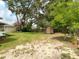 Spacious backyard with a storage shed and mature trees, offering a private outdoor space at 171 Stanley Bell Dr, Mount Dora, FL 32757