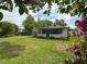 Expansive backyard with mature trees and a view of the house at 171 Stanley Bell Dr, Mount Dora, FL 32757