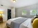 Bright bedroom featuring neutral walls, wood floors, shutters, and a convenient closet for storage at 171 Stanley Bell Dr, Mount Dora, FL 32757