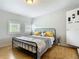 Bright bedroom with hardwood floors, two windows, and modern furnishings at 171 Stanley Bell Dr, Mount Dora, FL 32757