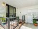Well-lit front porch with a black-trimmed glass door and decorative plants, enhancing the home's curb appeal and entry at 171 Stanley Bell Dr, Mount Dora, FL 32757
