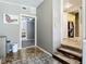 Bright hallway with unique stone flooring and access to other rooms at 171 Stanley Bell Dr, Mount Dora, FL 32757