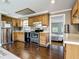 Bright kitchen boasts stainless steel appliances, wooden cabinets, and access to the bedroom at 171 Stanley Bell Dr, Mount Dora, FL 32757