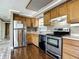 Well-equipped kitchen features stainless steel appliances, wooden cabinets, and plenty of counter space at 171 Stanley Bell Dr, Mount Dora, FL 32757