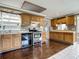 Functional kitchen with wooden cabinets, stainless steel appliances, and tiled countertops at 171 Stanley Bell Dr, Mount Dora, FL 32757