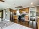Well-lit kitchen features stainless steel appliances, wooden cabinets, and hardwood flooring at 171 Stanley Bell Dr, Mount Dora, FL 32757