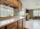 Open kitchen and living room showcasing a breakfast bar, stainless appliances, and natural light at 171 Stanley Bell Dr, Mount Dora, FL 32757