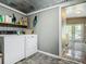 Functional laundry room with washer, dryer, and built-in shelving for storage solutions at 171 Stanley Bell Dr, Mount Dora, FL 32757