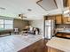 Open living room, hardwood floors, and an open kitchen with wood cabinets and stainless appliances at 171 Stanley Bell Dr, Mount Dora, FL 32757