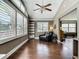 Bright living room with hardwood floors, plantation shutters, and a ceiling fan at 171 Stanley Bell Dr, Mount Dora, FL 32757