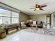 Cozy sitting area with neutral tile flooring, a ceiling fan, and a large window, ideal for relaxation and casual gatherings at 171 Stanley Bell Dr, Mount Dora, FL 32757