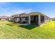 Spacious backyard featuring a pergola-covered patio and screened-in porch for seamless indoor-outdoor living at 17335 Million Lakes Ct, Clermont, FL 34714