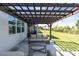 Cozy backyard patio under a pergola, offering a serene outdoor retreat with comfortable seating and scenic views at 17335 Million Lakes Ct, Clermont, FL 34714