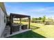Charming backyard patio with pergola and comfortable seating, creating an inviting outdoor living space at 17335 Million Lakes Ct, Clermont, FL 34714