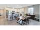 Bright, open kitchen with stainless steel appliances and an island with barstool seating and dining area at 17335 Million Lakes Ct, Clermont, FL 34714