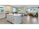 Open concept kitchen with stainless appliances and white cabinets that overlooks dining and living area at 17335 Million Lakes Ct, Clermont, FL 34714