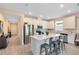 Bright kitchen with stainless steel appliances, island with seating, and white cabinetry at 17335 Million Lakes Ct, Clermont, FL 34714