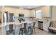 Kitchen featuring stainless steel appliances, island with seating, and white cabinetry at 17335 Million Lakes Ct, Clermont, FL 34714
