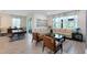 Open living room with neutral furniture and decor, flowing into dining area, and lots of light at 17335 Million Lakes Ct, Clermont, FL 34714