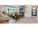 Cozy living room with fireplace, TV, built-in shelving, and plenty of natural light at 17335 Million Lakes Ct, Clermont, FL 34714