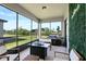 Relaxing screened patio with outdoor grill, seating area, and views of the backyard at 17335 Million Lakes Ct, Clermont, FL 34714