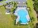 Community pool with lounge chairs, a covered area and a playground nearby at 17335 Million Lakes Ct, Clermont, FL 34714