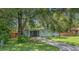 Attractive home featuring a neatly manicured lawn, driveway, and mature shade trees at 1881 Cottonwood St, Orange City, FL 32763