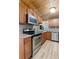 Well-lit kitchen featuring stainless steel appliances, granite counters, and wood cabinets at 1881 Cottonwood St, Orange City, FL 32763