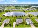 Stunning aerial view of a home with a screened pool, set on a large lot near a lake at 2260 Grayling St, Orlando, FL 32820