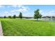 Lush green backyard with a serene lake view and picturesque landscaping at 2260 Grayling St, Orlando, FL 32820