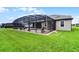 Exterior view of a home featuring a screened lanai, manicured lawn, and outdoor living at 2260 Grayling St, Orlando, FL 32820