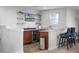 Home bar with granite counters, wine fridge, and shelving, perfect for entertaining at 2260 Grayling St, Orlando, FL 32820