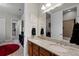 Double sinks with granite countertop with views of a hallway and a partially visible secondary bathroom at 2260 Grayling St, Orlando, FL 32820